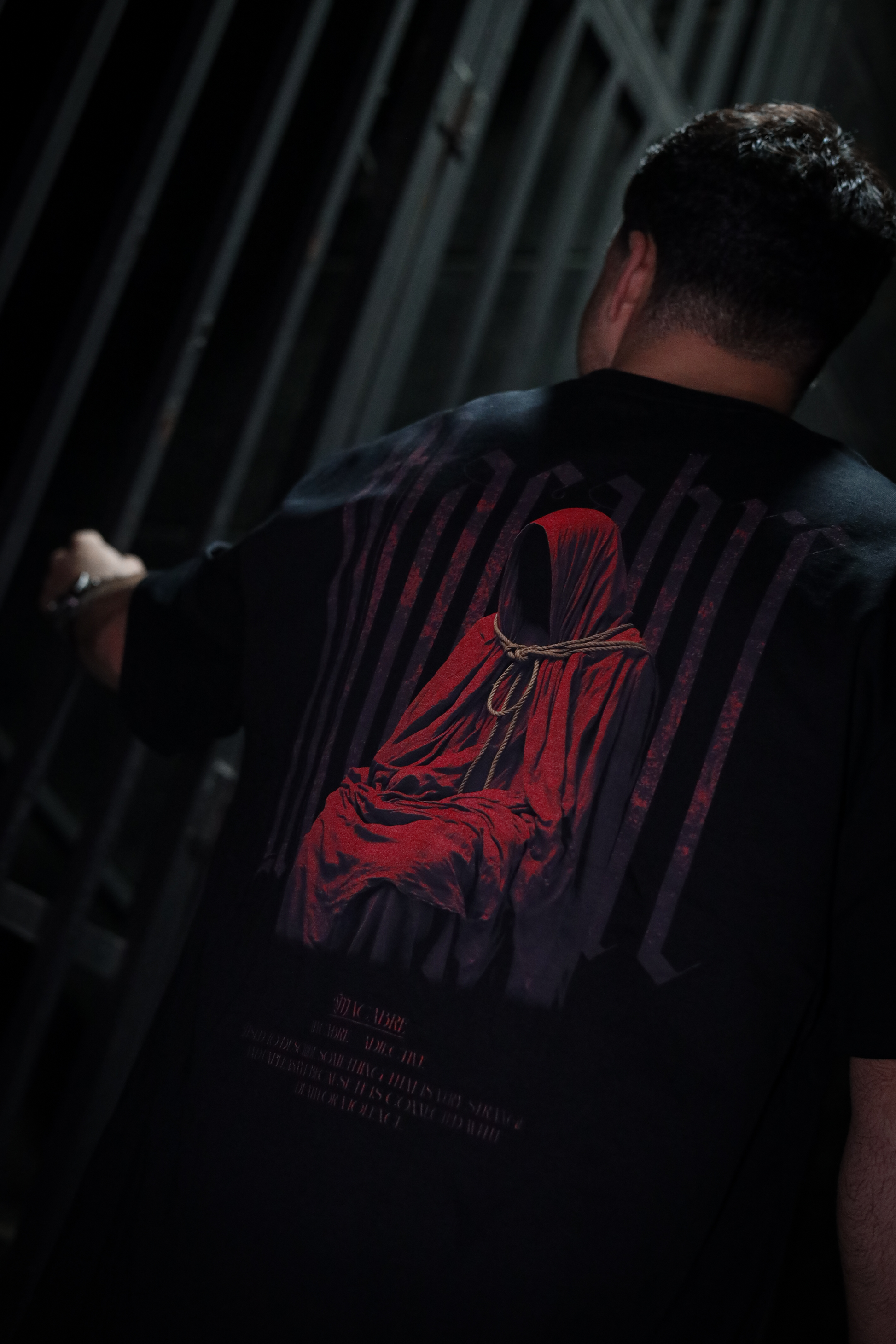 TRGDY black oversized “Macabre” tee, rear view, heavyweight baggy t-shirt depicting unsettling macabre design, dark streetwear