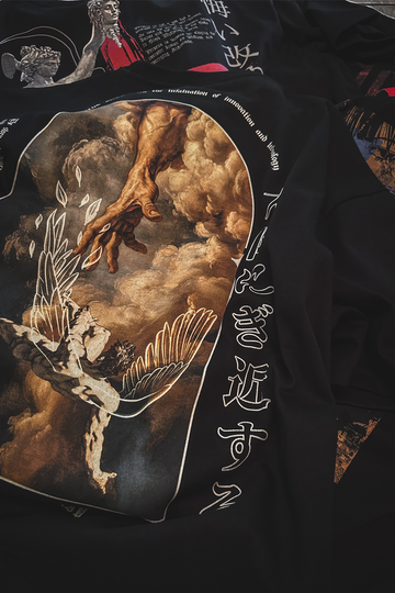 Black oversize t- shirt with artistic design featuring a hand and feathers.