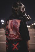 TRGDY “TWS” black oversized tee, rear view, baggy fit with gas mask and Japanese text graphic, dark streetwear shirt